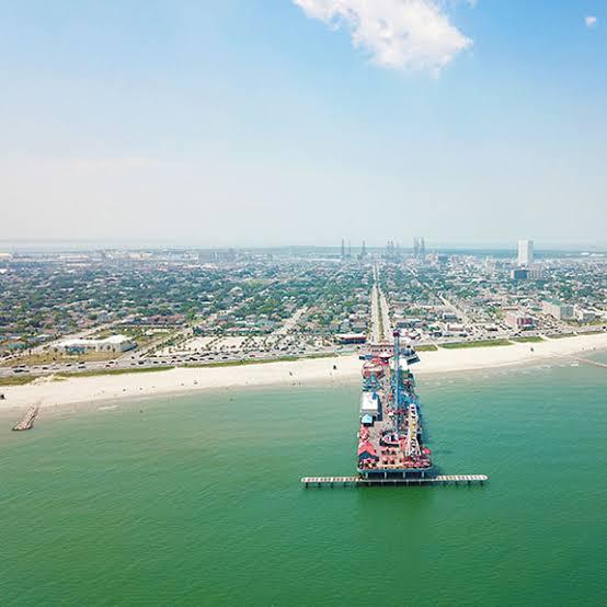 Aerial view of a pier stretching into the ocean